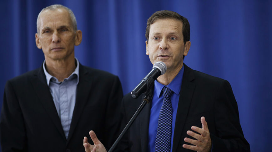 Isaac Herzog (R), the newly elected head of Israel's left-of-centre Labour Party, speaks during a news conference after his meeting with Palestinian President Mahmoud Abbas in the West Bank city of Ramallah December 1, 2013. REUTERS/Mohamad Torokman (WEST BANK - Tags: POLITICS) - RTX15ZO7