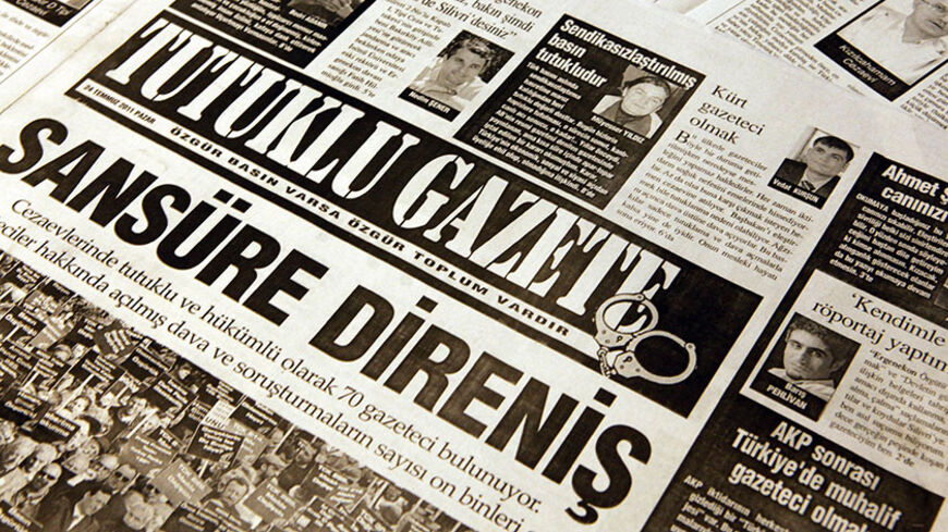 A copy of Tutuklu Gazete, published as a free supplement in leftist Turkish newspapers on Sunday July 24, 2011, is seen in this photo illustration taken in Istanbul July 25, 2011. The dozens of Turkish journalists writing for the Tutuklu Gazete newspaper have very personal reasons to be concerned about media freedom in their EU-candidate country. They are all in jail. From prison cells across Turkey, they have contributed articles to a paper protesting against restrictions on freedom of expression which hav