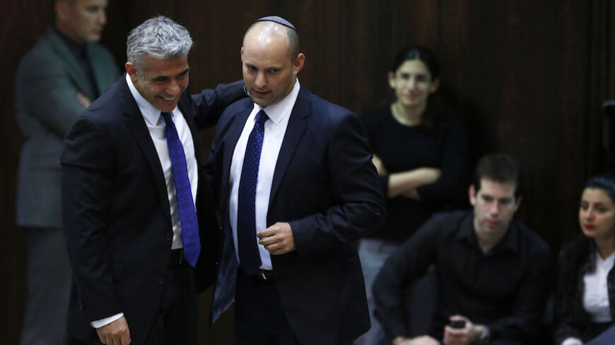 Israel's Finance Minister Yair Lapid (L) and Minister of Economics and Trade Naftali Bennett (2nd L) walk together during the swearing-in ceremony, at the Knesset, the Israeli Parliament, in Jerusalem March 18, 2013. Israeli Prime Minister Benjamin Netanyahu's new governing coalition took office after a parliamentary vote on Monday with powerful roles reserved for supporters of settlers in occupied territory. REUTERS/Baz Ratner (JERUSALEM - Tags: POLITICS) - RTR3F5XP