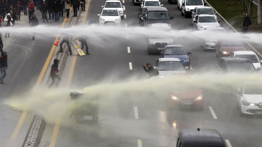 Riot police use water cannon to disperse anti-government protesters near the Middle East Technical University (ODTU) in Ankara March 11, 2014. A 15-year-old Turkish boy who suffered a head injury during anti-government protests in Istanbul last June died on Tuesday after spending months in a coma, triggering renewed clashes between police and his family's supporters. Berkin Elvan, then aged 14, got caught up in street battles between police and protesters on June 16 after going out to buy bread for his fami
