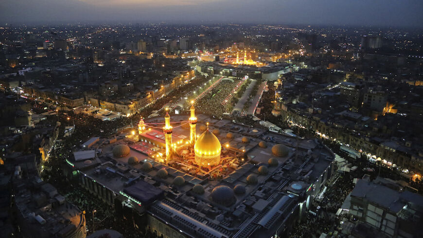 An aerial view shows the Shrines of Imam al-Abbas and Imam al-Hussein during the commemoration of Arbain in Kerbala, southwest of Baghdad December 13, 2014. Iraqi officials say millions of Shi'ite pilgrims from across Iraq and neighbouring countries are expected in Kerbala for Saturday's Arbain ritual, which marks the last of 40 days of mourning for the death of Imam Hussein that happened around 1,300 years ago. REUTERS/Abdul-Zahra (IRAQ - Tags: CITYSCAPE SOCIETY RELIGION TPX IMAGES OF THE DAY) - RTR4HVZY