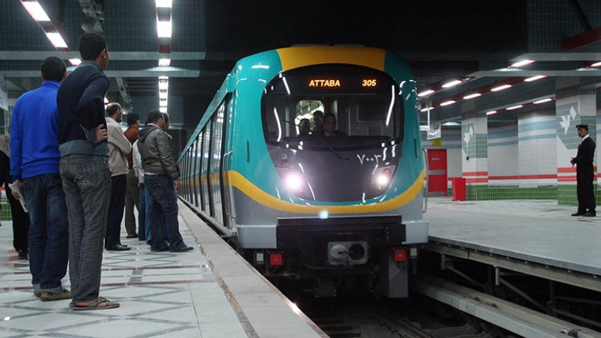Passengers are seen waiting for the arrival of the train at a station on the new metro line in Cairo which opened on February 21, 2012, linking the central Ataba district with the subrub of Abbasiya, two of the Egyptian capital's busiest neighborhoods. AFP PHOTO/STR (Photo credit should read STR/AFP/Getty Images)