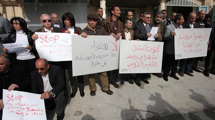 Palestinian journalists hold placards during a demonstration in support with reporters detained by Hamas in Gaza and to ask for their immediate release on January 27, 2013 in the West Bank city of Ramallah.  AFP PHOTO/ABBAS MOMANI        (Photo credit should read ABBAS MOMANI/AFP/Getty Images)