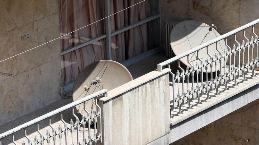 A general view taken on August 27, 2014 shows satellite dishes on balconies in northern Tehran. A new campaign has been launched by Iranian police to seize satellite dishes which are banned in Iran, the official IRNA news agency said. AFP PHOTO/ATTA KENARE        (Photo credit should read ATTA KENARE/AFP/Getty Images)