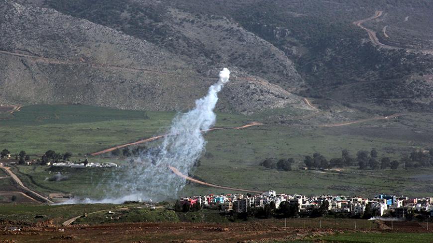 Smoke from Israeli shelling covers the Lebanese town of Al-Majidiyah (L) on the Lebanese border with Israel as the town of Al-Ghajar is seen on the right on January 28, 2015. Lebanese Shiite militant group Hezbollah claimed responsibility on Wednesday for an attack against a military convoy in an Israeli-occupied border area. AFP PHOTO / ALI DIA        (Photo credit should read ALI DIA/AFP/Getty Images)