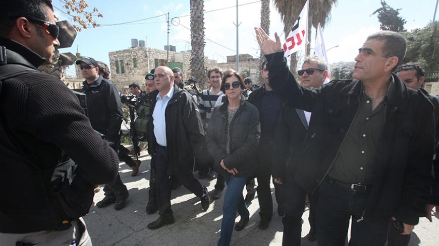 Israeli Meretz party members Nitzan Horowitz (2nd from R), Zehava Galon (C) and Issawi Frej (c-L) take part in a visit of the "Al-Shuhada" street in the West Bank city of Hebron on February 25, 2014 in support of Palestinians who were forced out of the old quarter at the outset of the second Palestinian intifada by the Israeli army to allow for Jewish settlers to move securely in the area. Today also marks the 20th anniversary of the massacre of 29 Palestinian Muslim worshipers by Jewish extremist Baruch Go