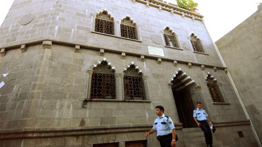 Turkish police officers stand outside a basalt-stone Diyarbakir Evangelical Church in Diyarbakir July 19, 2004. A Turkish man described as mentally ill set fire to part of a Christian church in southeastern Turkey on Monday before authorities were able to subdue him, officials said. A 27-year-old shouting anti-American slogans broke into the Diyarbakir Evangelical Church and barricaded himself in the building's library and kitchen before vandalising property and lighting a fire. No one was hurt in the blaze