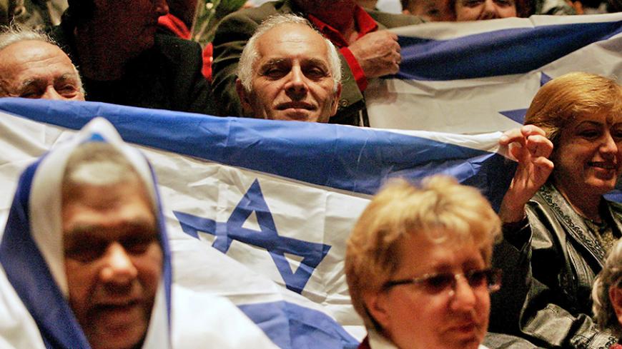 Former Soviet Union immigrants attend a pre-election campaign rally in the central Israeli town of Holon March 15, 2006. Israel's most influential electoral bloc is saying "Nyet" to interim Prime Minister Ehud Olmert just days before his Kadima party is expected to win a general election. Picture taken March 15, 2006. To match feature ISRAEL-ELECTION-RUSSIANS   REUTERS/Eliana Aponte - RTR17HTF