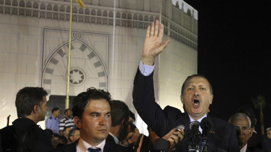 Turkey's Prime Minister Tayyip Erdogan speaks to the Libyan people on the 80th anniversary of the martyrdom of Libyan resistance hero Omar al-Mukhtar, near the shrine of his burial place in Benghazi September 16, 2011. Hundreds of Libyans joined Erdogan in prayer on Friday in Tripoli, heaping praise on him for backing the revolt against Muammar Gaddafi. The Turkish prime minister, who is promoting Ankara's blend of Islam and democracy as a model for North African states, hailed Libya's revolution by invokin
