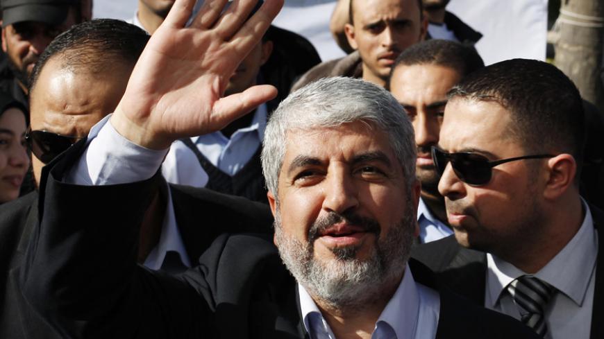 Hamas chief Khaled Meshaal waves upon arrival at Rafah crossing in the southern Gaza Strip December 7, 2012. Meshaal arrived in the Gaza Strip on Friday, ending 45 years of exile from Palestinian land with a visit that underscored the Islamist group's growing confidence following a recent conflict with Israel. REUTERS/Suhaib Salem (GAZA - Tags: POLITICS) - RTR3BB5G