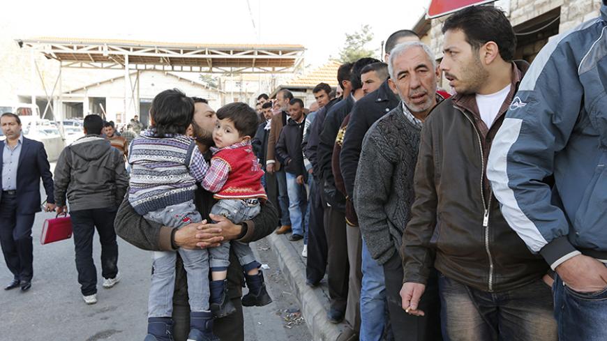 Syrians stand in a queue to get a visa stamp entering Lebanon town during their arrival at the Lebanese Masna'a border point in eastern Bekaa of Lebanon January 22, 2013. 
REUTERS/Jamal Saidi  (LEBANON - Tags: POLITICS CIVIL UNREST) - RTR3CSRV