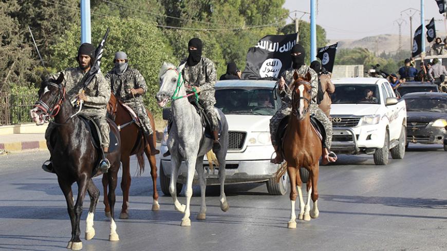 Militant Islamist fighters ride horses as they take part in a military parade along the streets of Syria's northern Raqqa province June 30, 2014. The fighters held the parade to celebrate their declaration of an Islamic "caliphate" after the group captured territory in neighbouring Iraq, a monitoring service said. The Islamic State, an al Qaeda offshoot previously known as Islamic State in Iraq and the Levant (ISIL), posted pictures online on Sunday of people waving black flags from cars and holding guns in