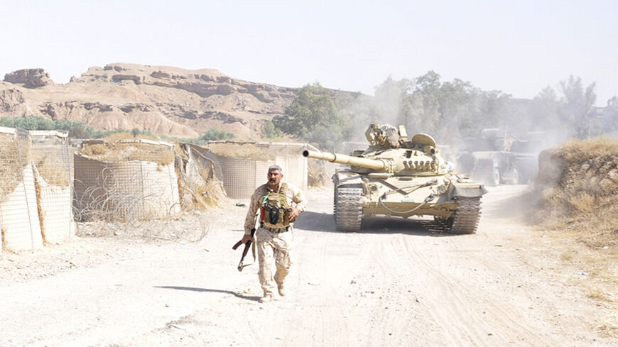A tank is pictured as Iraqi security forces patrol after clashes with militants of the Islamic State, formerly known as the Islamic State in Iraq and the Levant (ISIL), in the Hamrin mountains in Diyala province July 16, 2014. The Iraqi army and allied Shi'ite militia forces are trying to push back the Sunni insurgents of the al Qaeda offshoot, who swept through northern Iraq last month to within 70 km (45 miles) of Baghdad. Picture taken July 16, 2014. REUTERS/Stringer (IRAQ - Tags: CIVIL UNREST POLITICS C
