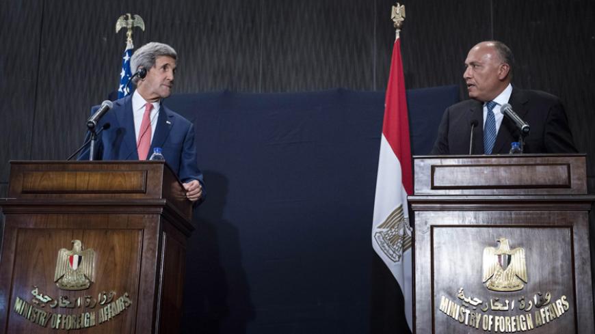 U.S. Secretary of State John Kerry (L) listens to Egypt's Foreign Minister Sameh Shoukry during a  joint news conference in Cairo September 13, 2014. Kerry said on Saturday that Egypt has a critical role to play in countering Islamic State's ideology. Kerry is in Cairo as part of a regional tour to build support for President Barack Obama's plan to strike both sides of the Syrian-Iraqi frontier to defeat Islamic State Sunni fighters and build a coalition for a potentially complex military campaign in the he