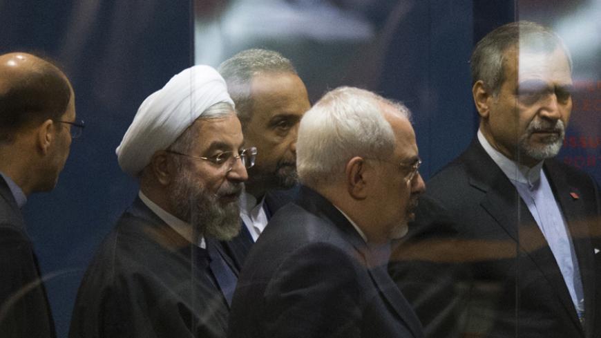 Iranian President Hassan Rouhani is surrounded by security while commuting to meetings on the sidelines of the 69th United Nations General Assembly at the United Nations Headquarters in New York, September 25, 2014. Rouhani blamed the rise of violent extremism on "certain states" and on unidentified "intelligence agencies" and said it was up to the region to find a solution to the problem. REUTERS/Adrees Latif  (UNITED STATES - Tags: POLITICS) - RTR47PL1