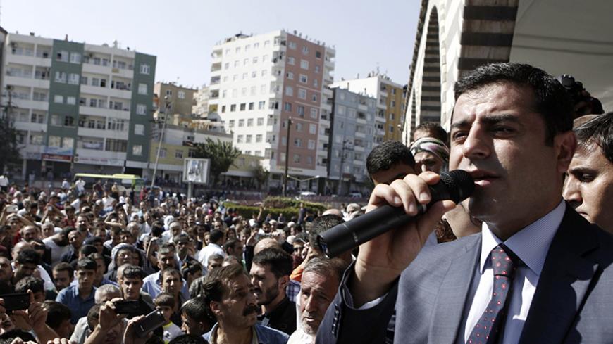 Selahattin Demirtas, co-chair of the HDP, Turkey's leading Kurdish party, addresses his supporters in Diyarbakir October 9, 2014. Islamic State fighters launched a renewed assault on the Syrian city of Kobani on Wednesday night, and at least 21 people were killed in riots in neighbouring Turkey where Kurds rose up against the government for doing nothing to protect their win. REUTERS/Osman Orsal (TURKEY - Tags: POLITICS CIVIL UNREST) - RTR49I8X