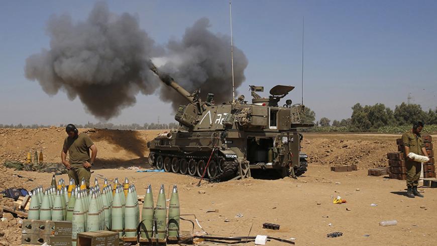 An Israeli mobile artillery unit fires towards the southern Gaza in this August 1, 2014 file photo. The July-August war in Gaza drew international condemnation for a number of reasons, but one episode proved more deadly than any other: an Israeli air and artillery bombardment on Aug. 1 that killed 150 people in a matter of hours.The events unfolded just as a three-day ceasefire was supposed to come into force. Hamas militants emerged from a tunnel inside Gaza and ambushed three Israeli soldiers, killing two
