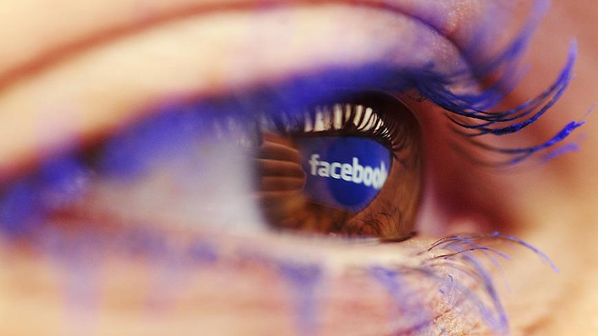A Facebook logo reflected in the eye of a woman is seen in this picture illustration taken in Skopje November 6, 2014. Picture take November6.  REUTERS/Ognen Teofilovski (MACEDONIA  - Tags: BUSINESS LOGO)   - RTR4DKUK
