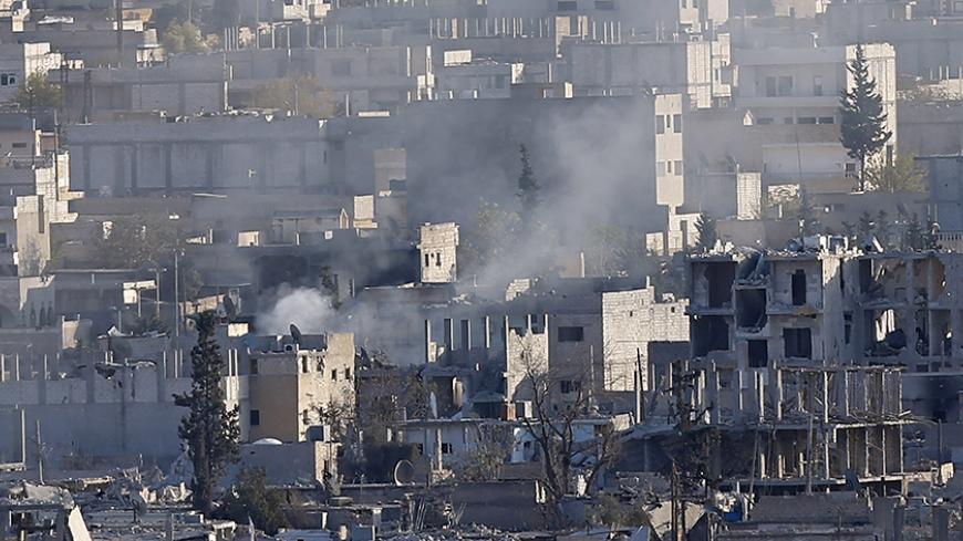 A view shows smoke raising from an eastern Kobani neighbourhood, damaged by fighting between Islamic State militants and Kurdish forces, November 18, 2014. Picture taken from the Turkish side of the Turkey-Syria border. REUTERS/Osman Orsal (SYRIA - Tags: CONFLICT CIVIL UNREST) - RTR4ELGD