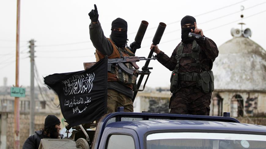 Members of al Qaeda's Nusra Front gesture as they drive in a convoy touring villages, which they said they have seized control of from Syrian rebel factions, in the southern countryside of Idlib, December 2, 2014. Picture taken December 2, 2014. 
REUTERS/Khalil Ashawi (SYRIA - Tags: CIVIL UNREST CONFLICT) - RTR4GJ39