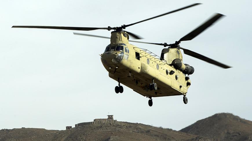 A CH-47 Chinook helicopter from the 82nd Combat Aviation Brigade lands to pick up U.S. soldiers from the 3rd Cavalry Regiment after an advising mission at the Afghan National Army headquarters for the 203rd Corps in the Paktia province of Afghanistan December 21, 2014. REUTERS/Lucas Jackson (AFGHANISTAN - Tags: CIVIL UNREST POLITICS MILITARY TRANSPORT) - RTR4IUN7