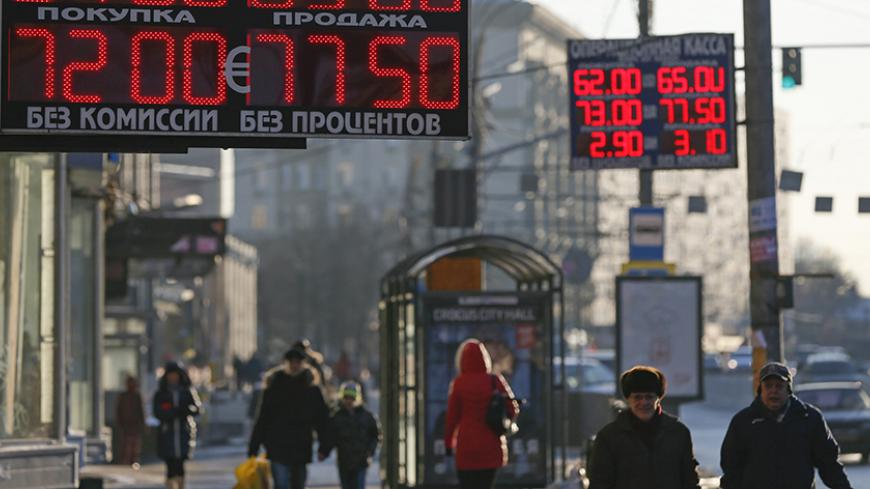 Boards showing currency exchange rates are seen in Moscow, January 7, 2015. Many emerging market currencies weakened on Wednesday, weighed down by oil prices hitting fresh lows, with Russian assets feeling most of the pain. South Africa's rand, Turkey's lira, and the Russian rouble all traded lower against the dollar, after oil prices fell below $50 barrel for the first time since 2009. REUTERS/Maxim Shemetov (RUSSIA - Tags: BUSINESS) - RTR4KE1X