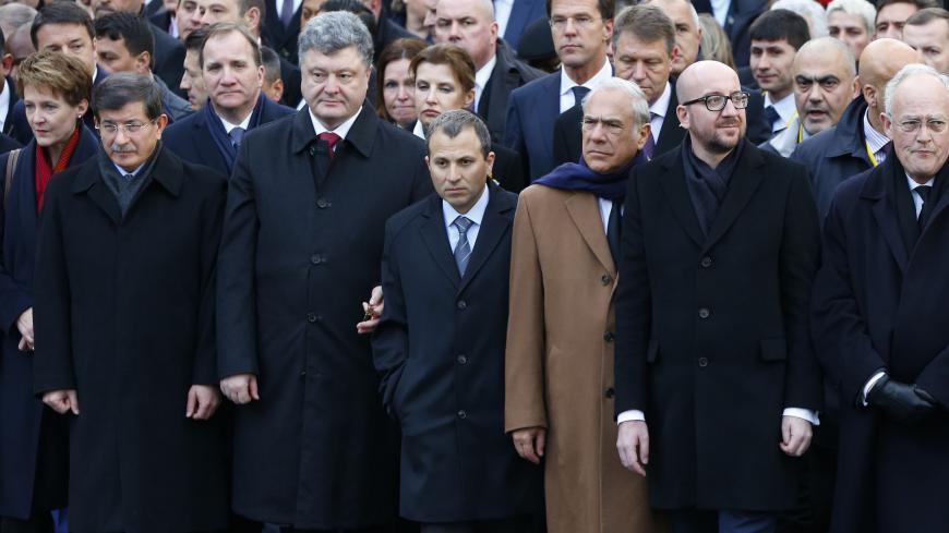 Switzerland's President Simonetta Sommaruga (L), Turkey's Prime Minister Ahmet Davutoglu (2ndL), Ukraine's President Petro Poroshenko (3rdL), Organization for Economic Co-operation and Development (OECD) Secretary-General Angel Gurria (3rdR), Belgian Prime Minister Charles Michel (2ndR) take part with dozens of foreign leaders in a solidarity march (Marche Republicaine) in the streets of Paris January 11, 2015. Hundreds of thousands of French citizens will be joined by dozens of foreign leaders, among them 