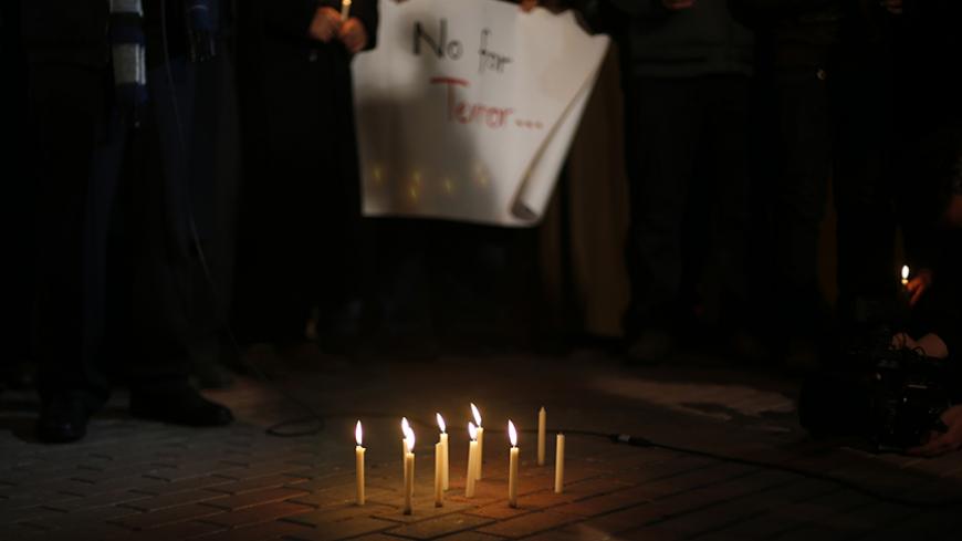 Lit candles are seen on the ground during a protest against the attack in Paris earlier this week on the offices of satirical French newspaper Charlie Hebdo, outside the French Cultural Center in Gaza city January 11, 2015. REUTERS/Suhaib Salem (GAZA - Tags: POLITICS CIVIL UNREST CRIME LAW) - RTR4KXHF