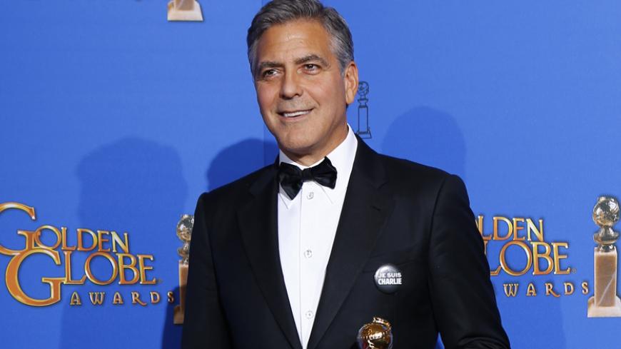 Honoree actor George Clooney poses with the Cecille B. DeMille award backstage at the 72nd Golden Globe Awards in Beverly Hills, California January 11, 2015.   REUTERS/Mike Blake  (UNITED STATES  - Tags: ENTERTAINMENT)    (GOLDENGLOBES-BACKSTAGE) - RTR4KZXT