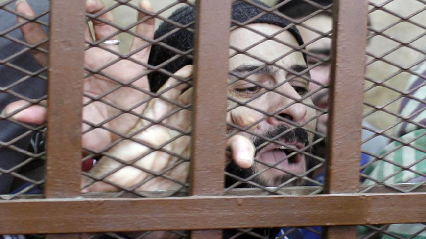 Defendants react after hearing the verdict at a court in Cairo January 12, 2015.  An Egyptian court on Monday ordered the release of 26 men who were detained last month in a raid on a Cairo bath house after police received a tip that they were holding gay orgies."The court has ruled that all the accused are innocent," the judge said.  REUTERS/Asmaa Waguih (EGYPT - Tags: POLITICS CRIME LAW CIVIL UNREST) - RTR4L2M4
