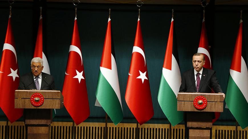 Turkey's President Tayyip Erdogan and Palestinian President Mahmoud Abbas (L) address the media at the Presidential Palace in Ankara January 12, 2015. REUTERS/Umit Bektas (TURKEY - Tags: POLITICS) - RTR4L5C4