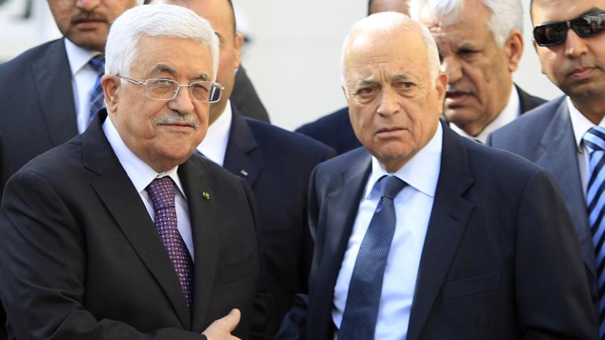 Palestinian President Mahmoud Abbas (L) stands with Arab League Secretary-General Nabil al-Araby (R) following the Arab League Foreign Ministers emergency meeting held at the League's headquarters in Cairo January 15, 2015. REUTERS/Mohamed Abd El Ghany (EGYPT - Tags: POLITICS) - RTR4LJ7K