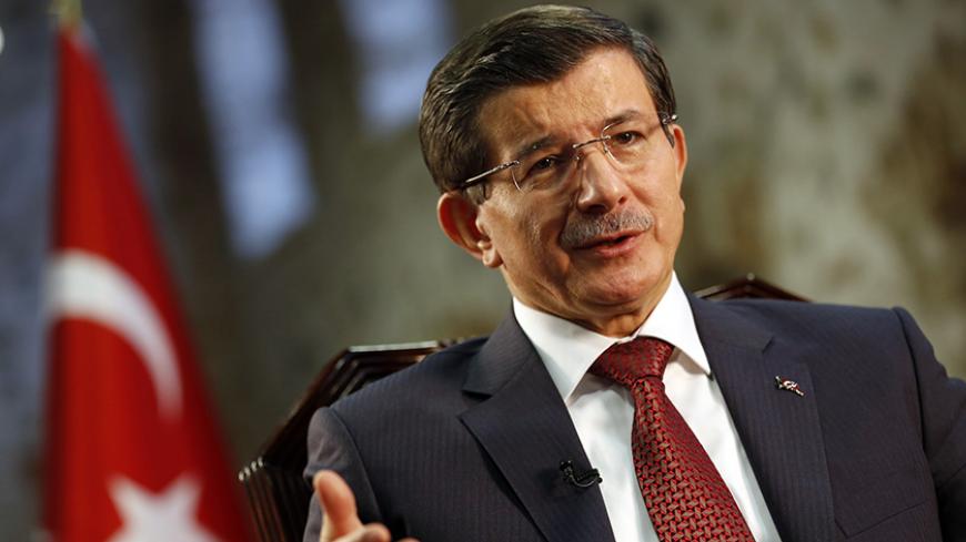 Turkey's Prime Minister Ahmet Davutoglu speaks during an interview with Reuters in Istanbul January 16, 2015. Davutoglu said on Friday the Syrian city of Aleppo must be protected from bombardment by President Bashar al-Assad's forces before Turkey would consider stepping up its role in the U.S.-led coalition against Islamic State. REUTERS/Murad Sezer (TURKEY - Tags: POLITICS) - RTR4LQJ6