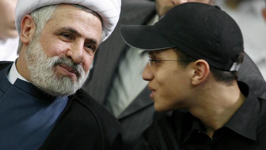 Jihad Moughniyah (R), son of Lebanon's Hezbollah late military leader Imad Moughniyah, sits beside Hizbollah Deputy Secretary General Naeem Kassem during a ceremony marking his fathers 40th death in Beirut's suburbs in this March 24, 2008 file photo.  An Israeli helicopter strike in Syria killed Moughniyah, sources close to Hezbollah said, in a major blow that could lead to reprisal attacks. The strike hit a convoy carrying Jihad Moughniyah and other Hezbollah members including commander Abu Issa, in the Sy