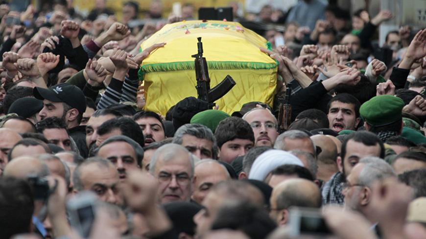 Lebanon's Hezbollah members carry the coffin of Jihad Moughniyah during his funeral in Beirut's suburbs January 19, 2015. The son of Hezbollah's late military leader Imad Moughniyah was killed in an Israeli helicopter strike in Syria on Sunday, a statement from the group said. The man (bottom C, wearing glasses) is the head of Hezbollah's parliamentary bloc Mohamed Raad. REUTERS/Aziz Taher (LEBANON - Tags: OBITUARY MILITARY POLITICS CIVIL UNREST) - RTR4M0GK