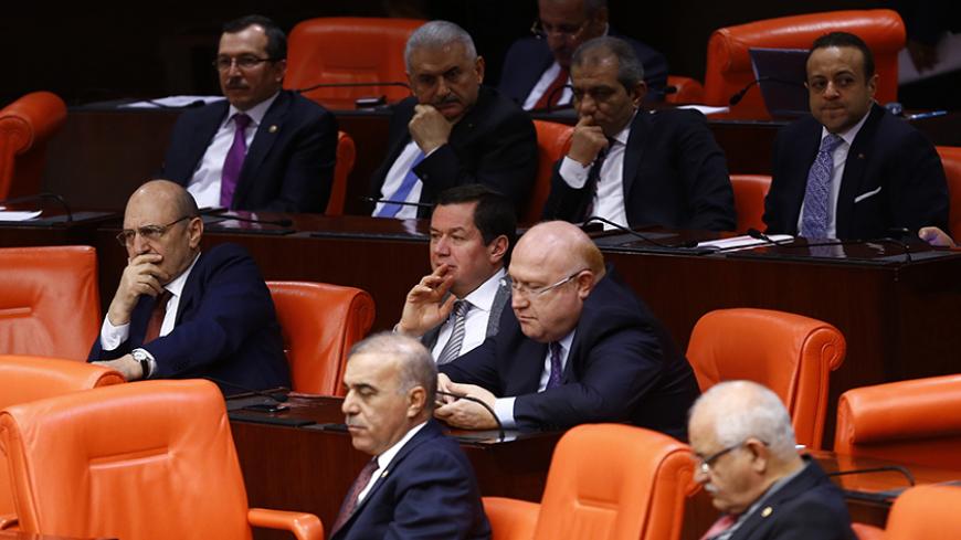 Former European Affairs minister Egemen Bagis (R, rear row) and former Environment and City Planning minister Erdogan Bayraktar (L) attend a debate at the Turkish parliament in Ankara January 20, 2015. The parliament is due to vote on Tuesday on whether to commit four former ministers, including Bagis and Bayraktar, for trial over corruption allegations. REUTERS/Umit Bektas (TURKEY - Tags: POLITICS CRIME LAW) - RTR4M6MI