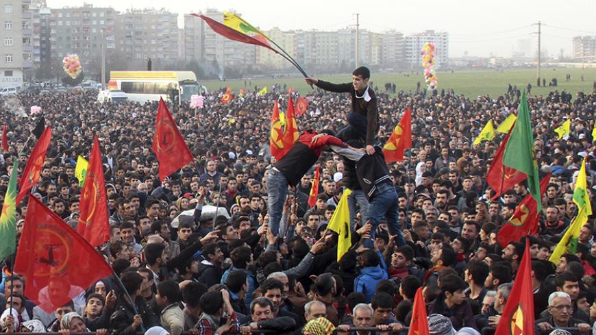 People gather to celebrate in the Kurdish-dominated city of Diyarbakir in southeastern Turkey, after Kurdish forces said they took full control of the Syrian town of Kobani, January 27, 2015. Kurdish forces battled Islamic State fighters outside Kobani on Tuesday, a monitoring group said, a day after Kurds said they took full control of the northern Syrian town following a four-month battle. REUTERS/Sertac Kayar (TURKEY - Tags: POLITICS CIVIL UNREST CONFLICT) - RTR4N6SW