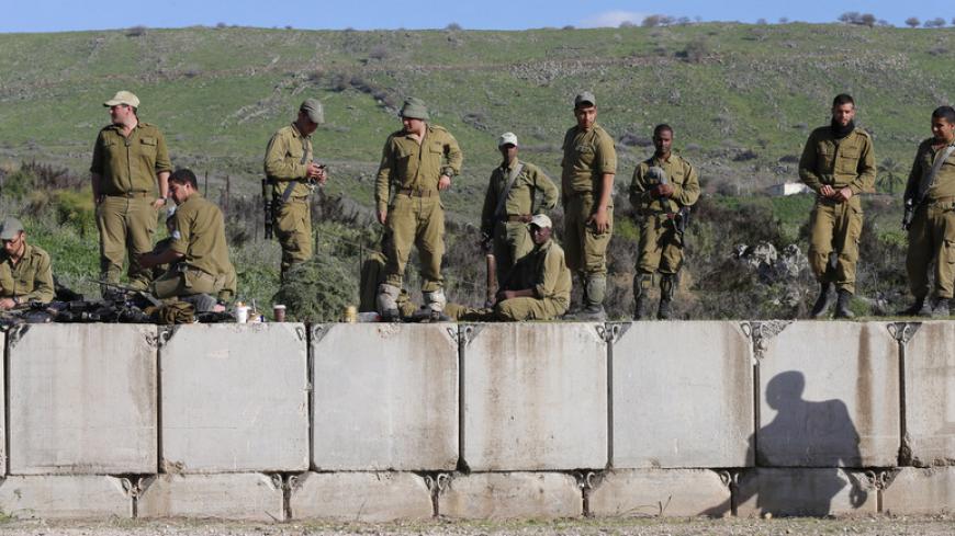 Israeli soldiers stand on concrete blocks near the border with Lebanon January 29, 2015. Israel and Hezbollah signalled on Thursday their rare flare-up in fighting across the Israel-Lebanon border was over, after the Lebanese guerrillas killed two Israeli troops in retaliation for a deadly air strike in Syria last week. REUTERS/Ammar Awad (ISRAEL - Tags: POLITICS MILITARY CONFLICT) - RTR4NHGX