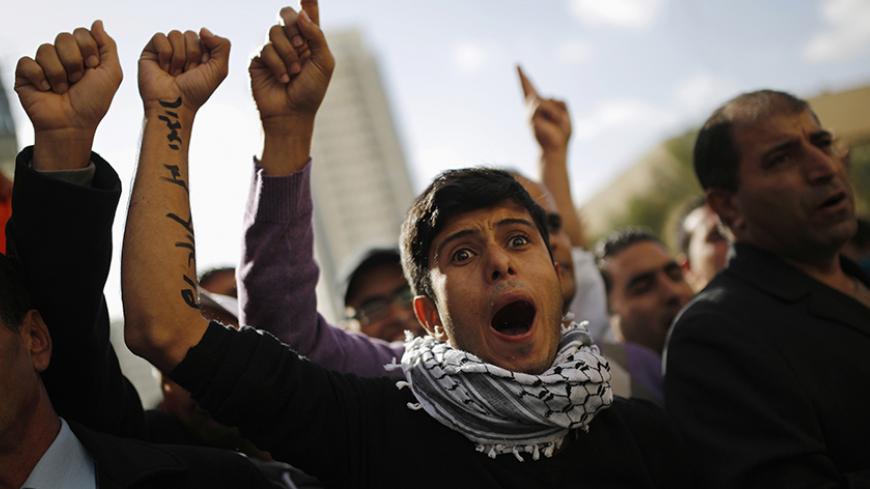 Members of the Bedouin community gesture during a protest outside a court in the southern city of Beersheba, calling to release people who were arrested last Saturday in protests against a government plan to force 40,000 Bedouins living in the southern Negev region to leave their villages, December 5, 2013. Hundreds of Bedouin Arabs and their supporters clashed with Israeli forces on Saturday in the protests, in which, according to an Israeli police spokesman, at least 28 people had been arrested. REUTERS/A