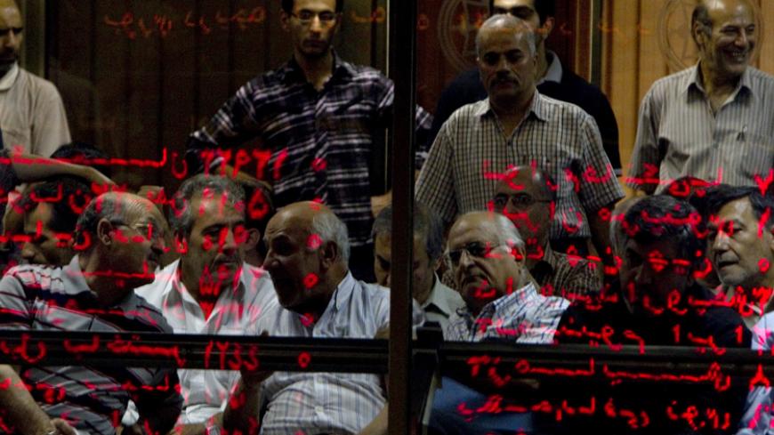 EDITORS' NOTE: Reuters and other foreign media are subject to Iranian restrictions on their ability to report, film or take pictures in Tehran. 

Investors look at an electronic display board, reflected in a glass partition, at the Tehran stock exchange September 15, 2010. Picture taken September 15, 2010. While U.S. diplomats were busy upping Iran's economic punishment over nuclear activities Washington fears are aimed at making a bomb, Iranian shares, which might have been expected to fall, have, instead,