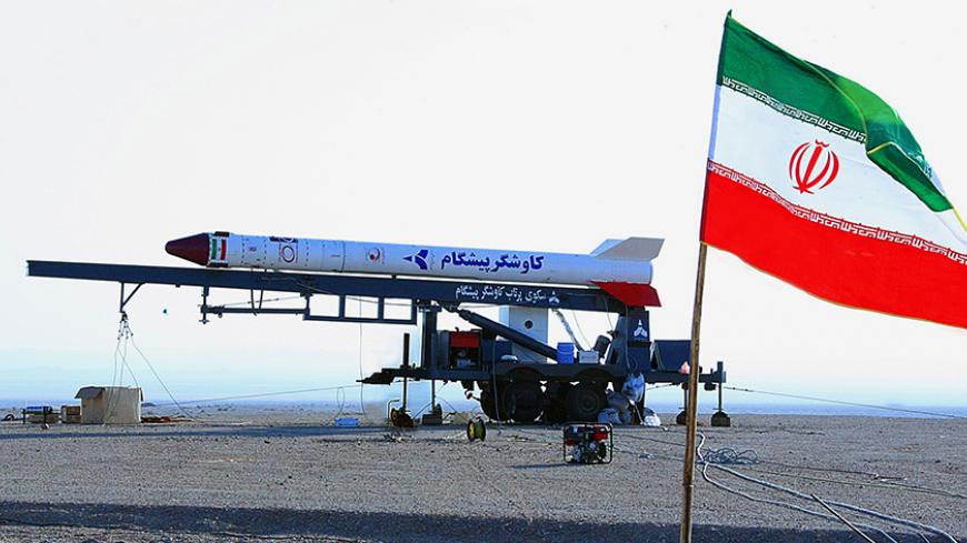 A picture shows the Iranian flag fluttering in front of a capsule, codenamed Pishgam (Pioneer), containing a live monkey at an unknown location on January 28, 2013, which Iranian news agencies said returned alive after travelling to an altitude of 120 kilometres (75 miles) for a sub-orbital flight. Iran took a "big step" towards sending astronauts into space by 2020, successfully launching a monkey above the Earth's atmosphere, Defence Minister Ahmad Vahidi told state television. AFP PHOTO/IRNA/STR        (