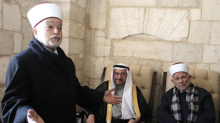 Iyad bin Amin Madani, secretary general of the Organization of Islamic Cooperation (C) meets with the Mufti of Jerusalem Mohammed Hussein (L) during his visit to the Al-Aqsa mosque compound, Islam's third holiest site, in the old city of Jerusalem on January 5, 2015. AFP PHOTO/ AHMAD GHARABLI        (Photo credit should read AHMAD GHARABLI/AFP/Getty Images)