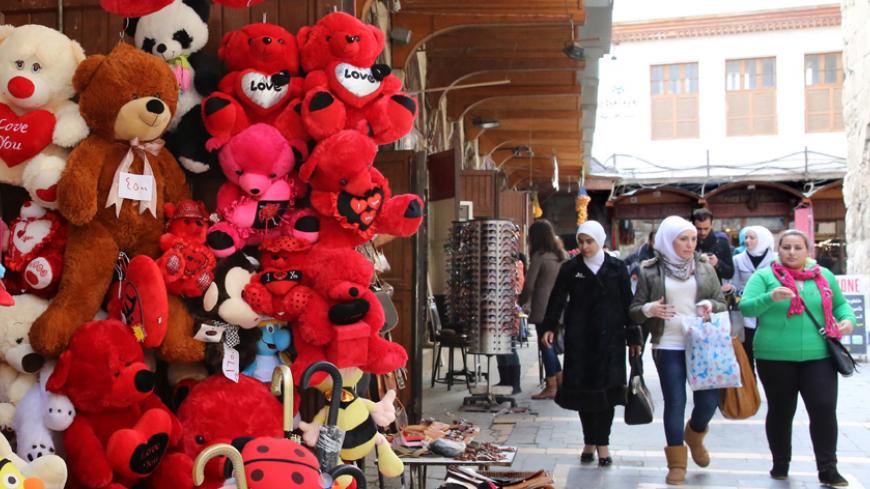 Syrian women walk past items on display at a shop in Damascus on Valentine's day on February 14, 2015.  AFP PHOTO / LOUAI BESHARA        (Photo credit should read LOUAI BESHARA/AFP/Getty Images)