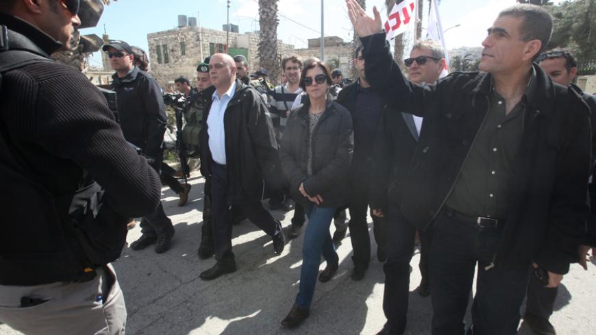 Israeli Meretz party members Nitzan Horowitz (2nd from R), Zehava Galon (C) and Issawi Frej (c-L) take part in a visit of the "Al-Shuhada" street in the West Bank city of Hebron on February 25, 2014 in support of Palestinians who were forced out of the old quarter at the outset of the second Palestinian intifada by the Israeli army to allow for Jewish settlers to move securely in the area. Today also marks the 20th anniversary of the massacre of 29 Palestinian Muslim worshipers by Jewish extremist Baruch Go