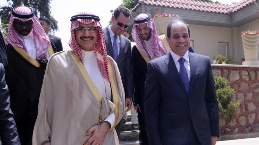Egypts ex-army chief and presidential candidate Abdel Fattah al-Sisi (R) walks alongside Saudi Prince al-Walid Bin Talal during a meeting in Cairo on May 19, 2014. Abdel Fattah al-Sisi  is Egypt's presidential frontrunner in the May 26-27 election. AFP PHOTO / STR        (Photo credit should read STR/AFP/Getty Images)
