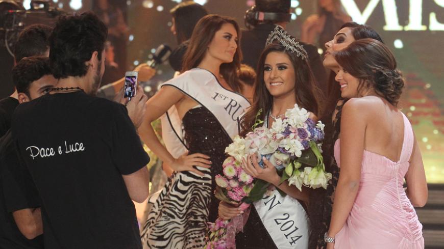 Sally Greige (C), 24, poses for photos after being  crowned Miss Lebanon 2014 in Beirut on October 5, 2014. AFP PHOTO/ANWAR AMRO        (Photo credit should read ANWAR AMRO/AFP/Getty Images)