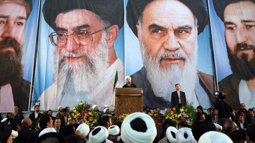 Iranian President Hassan Rouhani delivers a speech under portraits of Iran's supreme leader, Ayatollah Ali Khamenei (Center L) and Iran's founder of the Islamic Republic, Ayatollah Ruhollah Khomeini (Center R), on the eve of the 25th anniversary of the Islamic revolutionary leader Ayatollah Ruhollah Khomeini's death, at his mausoleum in a suburb of Tehran on June 3, 2014. AFP PHOTO / ATTA KENARE        (Photo credit should read ATTA KENARE/AFP/Getty Images)