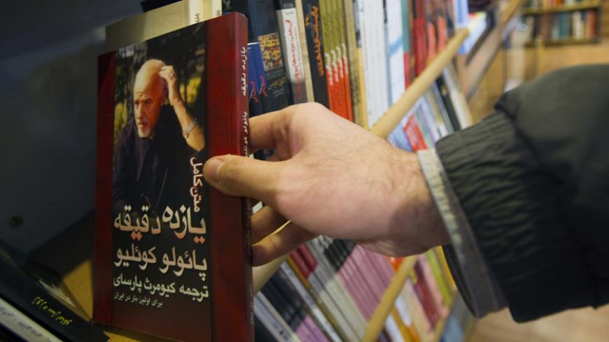 EDITORS' NOTE: Reuters and other foreign media are subject to Iranian restrictions on leaving the office to report, film or take pictures in Tehran.

A customer holds a copy of the translated novel "Eleven Minutes" written by the Brazilian novelist Paulo Coelho at a bookshop in central Tehran January 29, 2011. Iranians are feeling the pinch from radical cuts in state subsidies, a plan President Mahmoud Ahmadinejad has called "the biggest economic plan in the past 50 years". The cuts in long-standing subsidi