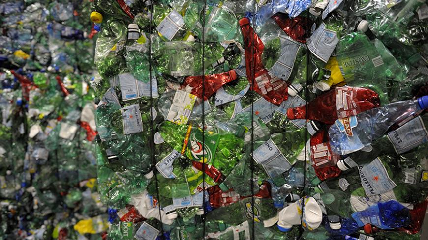 Crushed plastic bottles are seen at a recycling centre in Paris May 4, 2011. The recycling centre, which is the first one in Paris, has a capacity to treat around 15000 tons of wastes per year.   REUTERS/Philippe Wojazer  (FRANCE - Tags: SOCIETY BUSINESS ENVIRONMENT) - RTR2LZ8C