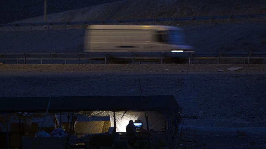 Bedouins of the Jahalin tribe watch television at their encampment, al-Khan al-Ahmar, in the Judean desert close to the road between Jericho and Jerusalem June 16, 2012. Bedouin tents and wandering goats dot the barren hills on the drive from Jerusalem down to the Dead Sea. But the Bedouin tradition is slowly dying out as Israel clears the camps to make way for expanding Jewish urban settlements. Picture taken June 16, 2012. To match Feature PALESTINIANS-ISRAEL/BEDOUIN .REUTERS/Darren Whiteside (WEST BANK -